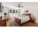 Bedroom with hardwood floors, ceiling fan, and bright natural light at 2613 Bedford Ave, Raleigh, NC 27607