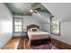 Cozy bedroom with wood floors, a ceiling fan, and two windows letting in natural light at 2613 Bedford Ave, Raleigh, NC 27607
