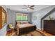 Comfortable bedroom with a ceiling fan, neutral colors, and natural light from the windows at 2613 Bedford Ave, Raleigh, NC 27607