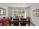 Bright dining room with hardwood floors, large window, and classic furniture at 2613 Bedford Ave, Raleigh, NC 27607