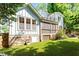 Charming two-story home with a landscaped yard, stone foundation, and an outdoor patio at 2613 Bedford Ave, Raleigh, NC 27607