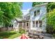 Charming two-story home with a landscaped yard, stone foundation, and an outdoor patio at 2613 Bedford Ave, Raleigh, NC 27607