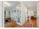 Bright hallway featuring hardwood floors, glass panel doors, and access to the living areas at 2613 Bedford Ave, Raleigh, NC 27607