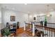 Hallway featuring hardwood floors, black railings, and an open view of a sitting area at 2613 Bedford Ave, Raleigh, NC 27607