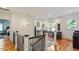 Bright hallway with hardwood floors, elegant chandelier, and a view of a bedroom at 2613 Bedford Ave, Raleigh, NC 27607