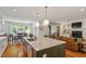 Kitchen island with white countertop and stainless steel sink overlooking the dining area and living room at 2613 Bedford Ave, Raleigh, NC 27607