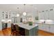 Modern kitchen with an island, stainless steel appliances, and pendant lighting at 2613 Bedford Ave, Raleigh, NC 27607