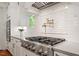 Modern kitchen with stainless steel appliances, tile backsplash, and ample countertop space at 2613 Bedford Ave, Raleigh, NC 27607