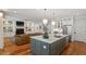 Open-concept kitchen with large island, stainless steel appliances, and view to the living room at 2613 Bedford Ave, Raleigh, NC 27607