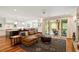 Open concept living room with hardwood floors, comfortable seating, and a sliding glass door at 2613 Bedford Ave, Raleigh, NC 27607