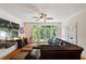 Cozy living room with a ceiling fan, glass doors to the outside, and a large sofa at 2613 Bedford Ave, Raleigh, NC 27607