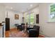 Cozy sitting area with natural light, hardwood floors, and comfortable leather armchairs at 2613 Bedford Ave, Raleigh, NC 27607