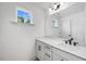 Bright bathroom with white cabinets, light countertops, and a large mirror at 2625 Stonington Dr, Cary, NC 27523