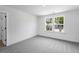 A carpeted bedroom features double windows allowing natural light at 2625 Stonington Dr, Cary, NC 27523