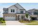 Beautiful two-story house with a two-car garage, a brick and white facade, and manicured landscaping at 2625 Stonington Dr, Cary, NC 27523