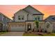 Charming two-story home featuring a brick and white facade, attached garage, and well-manicured lawn at 2625 Stonington Dr, Cary, NC 27523