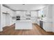 Modern kitchen with white cabinets, stainless steel appliances, a large island, and ample counter space at 2625 Stonington Dr, Cary, NC 27523