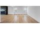 Expansive living room featuring wood flooring, natural light from large windows, and a modern fireplace at 2625 Stonington Dr, Cary, NC 27523