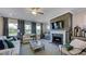 Living room featuring a fireplace, hardwood floors, and neutral furniture at 2625 Stonington Dr, Cary, NC 27523