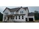 New construction home featuring a two-car garage and classic window design at 264 Alden Way, Angier, NC 27501
