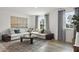 Inviting living room featuring stylish sectional sofa, modern coffee table, and large windows for ample natural light at 264 Alden Way, Angier, NC 27501