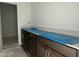 Bathroom featuring dark brown cabinets with blue protective film on the countertop at 2868 Quarry Rd # 167, Rolesville, NC 27571