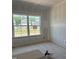 Bright bedroom featuring a large window with a view of the neighborhood, awaiting personal touches and decor at 2868 Quarry Rd # 167, Rolesville, NC 27571
