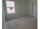 Empty bedroom featuring a double door closet and large window for natural light at 2868 Quarry Rd # 167, Rolesville, NC 27571