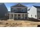 New two-story home featuring a charming front porch with white columns and gray siding at 2868 Quarry Rd # 167, Rolesville, NC 27571