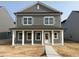 Charming two-story home with a covered front porch and classic architectural details in a suburban neighborhood at 2868 Quarry Rd # 167, Rolesville, NC 27571