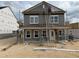 Exterior view of a two-story home under construction, showing workers and the house frame at 2868 Quarry Rd # 167, Rolesville, NC 27571
