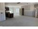 An unfinished, expansive living area with dark cabinets and a staircase awaiting your personal design at 2868 Quarry Rd # 167, Rolesville, NC 27571