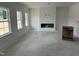 Spacious living room featuring large windows, fireplace, and ample space for customization in new construction at 2868 Quarry Rd # 167, Rolesville, NC 27571