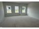 Bedroom with three windows, offering ample natural light in a new home at 2872 Quarry Rd # 166, Rolesville, NC 27571