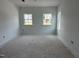 Bedroom with three windows, offering ample natural light in a new home at 2872 Quarry Rd # 166, Rolesville, NC 27571