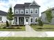 Charming two-story home with gray siding, white trim, covered porch, and a well-manicured lawn and landscaping at 2872 Quarry Rd # 166, Rolesville, NC 27571