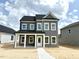 Charming two-story home featuring gray siding, white trim, and a welcoming front porch at 2872 Quarry Rd # 166, Rolesville, NC 27571