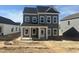 Charming two-story home featuring a covered porch and multiple windows, awaiting landscaping at 2872 Quarry Rd # 166, Rolesville, NC 27571