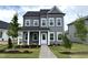 Charming two-story home with gray siding, white trim, covered porch, and a well-manicured lawn and landscaping at 2872 Quarry Rd # 166, Rolesville, NC 27571