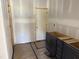 In-progress kitchen with dark base cabinets, and door to an adjacent room at 2872 Quarry Rd # 166, Rolesville, NC 27571