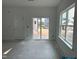 Bright living room featuring a sliding glass door and large window that provides natural light at 2872 Quarry Rd # 166, Rolesville, NC 27571