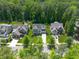 Aerial view of beautiful homes with manicured lawns and driveways in a neighborhood with mature trees and lush landscapes at 2993 Club Dr, Raleigh, NC 27613