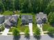 High angle aerial view of homes on well manicured streets with green lawns and mature trees in a friendly neighborhood at 2993 Club Dr, Raleigh, NC 27613