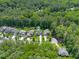 Overhead view of a home and its neighborhood nestled among lush, mature trees and greenery at 2993 Club Dr, Raleigh, NC 27613