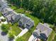 Beautiful aerial view of a home with a private backyard pool, lush landscaping, and a long driveway at 2993 Club Dr, Raleigh, NC 27613