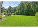 Large backyard featuring patio, outdoor seating, and mature trees for privacy at 2993 Club Dr, Raleigh, NC 27613