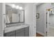 Bathroom featuring a granite vanity, framed mirror, and access to walk-in shower at 2993 Club Dr, Raleigh, NC 27613