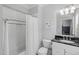 Bathroom features a tub/shower combo, marble countertops, and black and white tile flooring at 2993 Club Dr, Raleigh, NC 27613