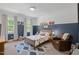 Bright bedroom featuring playful decor, a comfortable chair, and natural light from large windows at 2993 Club Dr, Raleigh, NC 27613