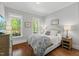 Bright bedroom with hardwood floors, neutral decor, and plenty of natural light at 2993 Club Dr, Raleigh, NC 27613
